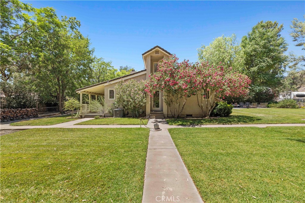 Incredible Opportunity – Ranch Living Just Minutes from Town!
Discover the rare chance to own a gated charming single-family ranch home on approximately 3.8 acres right off Bouquet Canyon Road with a circular driveway — just minutes from Santa Clarita’s shopping, dining, and conveniences, yet worlds away in serenity and space.
This single-story home offers 4 bedrooms, 2.5 baths, plus 4th bedroom or private guest suite has a separate entrance—ideal for multigenerational living, office, or rental potential. The inviting step-down living room features a cozy fireplace and opens to a sunroom filled with natural light. Enjoy a formal dining room with French doors leading to an expansive patio deck and fire pit, perfect for entertaining under the stars. Cooks kitchen with eat in bar area, nice light kitchen cabinetry, stainless appliances and built in cook top.
The primary suite includes a beautifully upgraded bath with soaking tub and separate walk in shower, dual sinks and floating shelves. The secondary bedroom features a built-in desk, ideal for study or work-from-home flexibility.
Gated entry with circular driveway, attached 2-car garage, and a large shed offer functionality and convenience. This property has potential for horses, livestock, gardens, storage for all of your favorite outdoor toys. Panoramic mountain views complete the peaceful setting.
With well water, septic system, and propane, this property offers cost-efficient rural living with all the convenience of being just a short drive to the city.
Whether you’re looking for a private retreat or small hobby farm, this unique property has it all!
