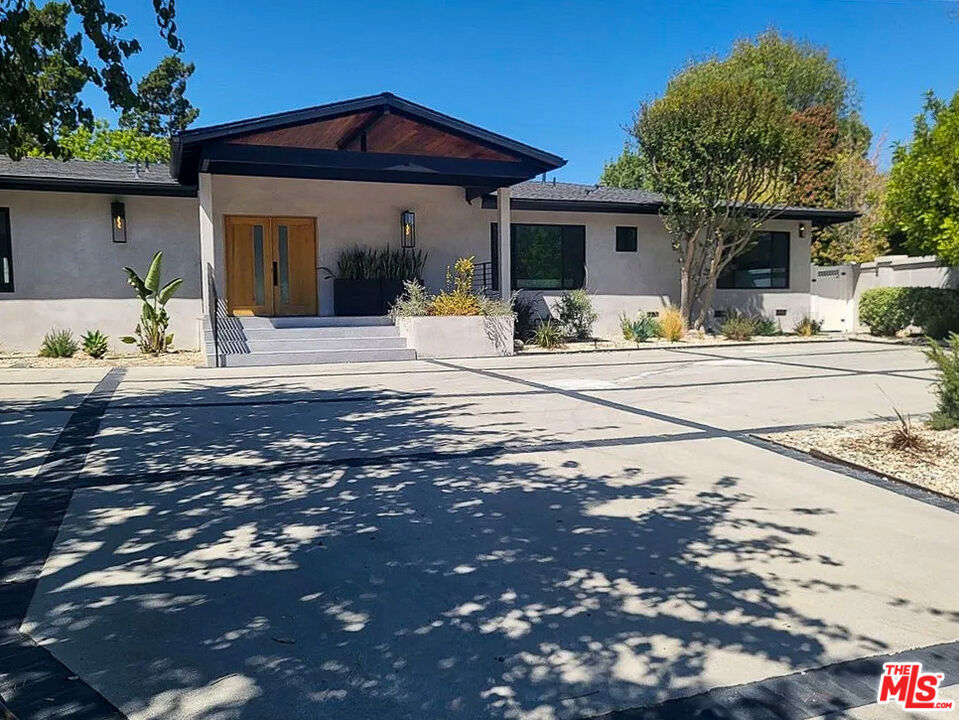 Step into luxury living with this stunning single-story retreat nestled in the heart of Encino, just south of Ventura Blvd. This home features 5 bedrooms, 4.5 bathrooms, and over 4,200 SQ FT of elegant living space. Gorgeous, engineered wood flooring, vaulted ceilings, and an open floor plan elevate everyday living. Gourmet kitchen with quartzite countertops, wine cooler, large waterfall island, Thor oven and gas range, and Dacor brand refrigerator, perfect for culinary adventures and entertaining guests. Whether you're working from home or enjoying leisure time, this property offers versatility and functionality. A bonus room off the kitchen is the ideal space for a game room, home office, home gym. Each bedroom is bathed in an abundance of inviting natural light, creating a warm and welcoming atmosphere throughout. The primary suite features a walk-in closet and en- suite complete with double vanity and relaxing rain shower. In addition to all the modern upgrades, this home is equipped with a Control 4 smart home system that connects to indoor speakers and exterior cameras. The backyard offers a sparkling pool complete with jacuzzi and Baja shelf, built-in BBQ, and spacious grassy area. Located near top public and private schools, popular restaurants and shopping destinations, parks, hiking trails, golf courses, and just minutes from the 101 and 405 freeways, this home offers convenience and connectivity within this highly sought-after Encino community. The house can be rented with or without furniture.
