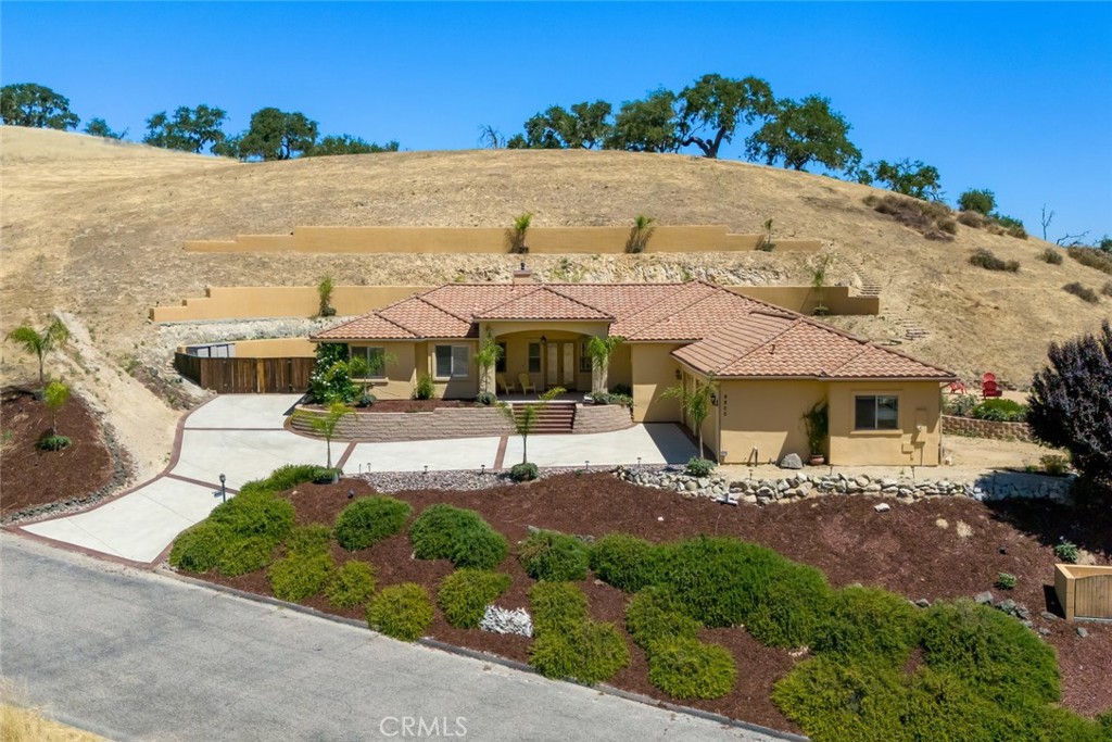 Lake Nacimiento's Mediterranean Estate Discover timeless elegance at 9805 Steelhead Rd--a private one-acre retreat near the shores of Lake Nacimiento. This beautifully designed estate features 4 spacious bedrooms and 3.5 baths, with hand-laid travertine floors, arched doorways, soaring ceilings, and rich cherry cabinetry throughout. The gourmet kitchen boasts an oversized granite island, premium stainless appliances, double ovens, and custom cabinetry, flowing into a formal dining room and an open great room perfect for entertaining. The primary suite offers a spa-like escape with dual vanities, a walk-in shower, and a deep Jacuzzi tub. Outdoors, enjoy stamped concrete walkways, lush landscaping, and panoramic views of rolling hills. A covered patio provides year-round enjoyment, and the elevated lot offers potential for a guest house or detached ADU--ideal multigenerational living. A rare blend of luxury, comfort, and possibility in a spectacular lakeside setting.