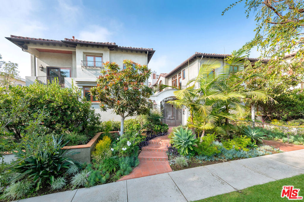 Prime Montana neighborhood location! This stunning end-unit townhouse offers 2 bedrooms and 2.5 bathrooms, situated just a 1/2 block from the shops and restaurants on Montana Avenue. The main living space features sliding glass doors that open to a private patio with a firepit. The kitchen is designed for entertaining, with a large island that seats four, custom cabinetry, and a Viking range. The primary bedroom boasts soaring ceilings, a balcony, a spacious walk-in closet, and a bathroom with dual sinks, a soaking tub, and a shower. The second bedroom includes a balcony, en-suite bathroom, and walk-in closet. The top floor features a loft space with a rooftop deck. Interior highlights include light wood floors, Sierra Pacific windows and doors, high ceilings, central heating, central A/C, built-in speakers, a Ring doorbell, and an in-unit laundry area. A private 2-car garage offers direct entry into the unit along with storage cabinets. The complex is gated, beautifully landscaped, and includes 2 guest parking spaces