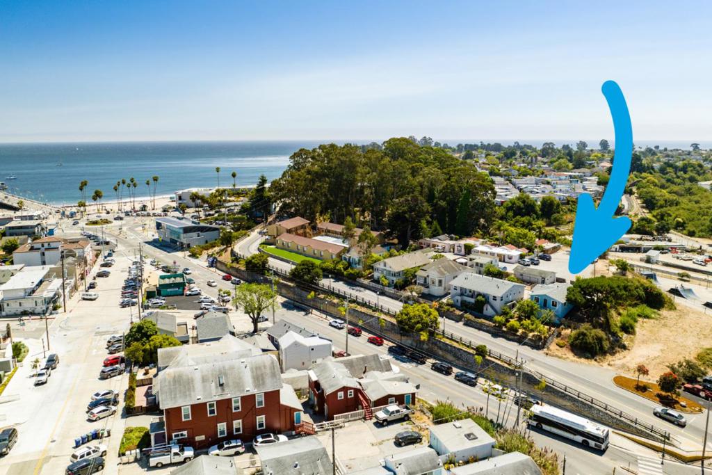 Special opportunity to own a piece of Santa Cruz history and a large piece of land near the beach. This offering includes a single family home plus an adjacent vacant lot, together totaling over 15,000 SF. The home is single level with an ocean peek from the front porch and sits in a unique, private location at the end of Viaduct Ct off West Cliff Drive, directly across from Beach Hill and near the Wharf, Boardwalk, and West Cliff Drive. Rare chance to purchase two parcels together, with the option to also buy the neighboring duplex at 108/110 W Cliff Drive separately. Buy all 3 for a once-in-a-lifetime opportunity to own your own section of Santa Cruz by the beach with upside potential.