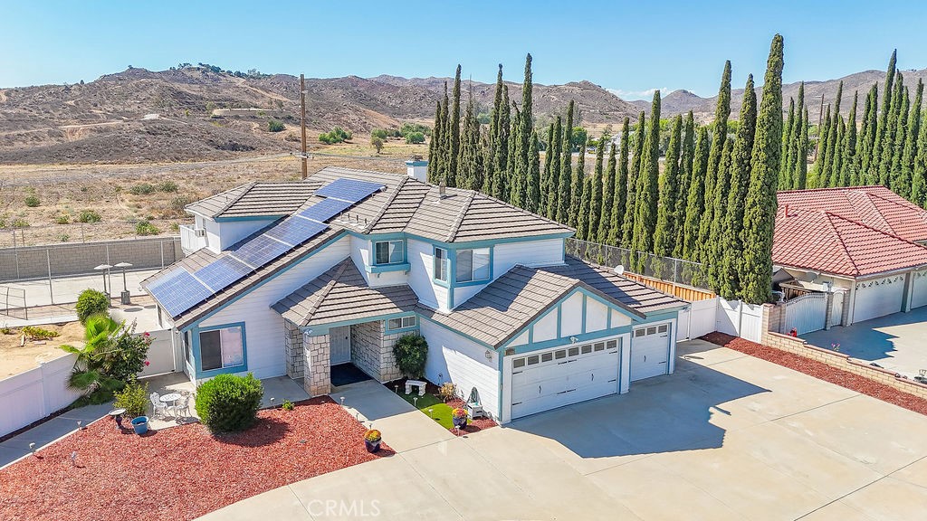 WELCOME HOME to this spacious 5-bedroom, 3-bath residence nestled on a half-acre lot in a peaceful Moreno Valley neighborhood. As you arrive, you’ll appreciate the low-maintenance landscaping, large circular driveway, RV parking, and three car garage. Step through the double doors and be greeted by BRAND NEW LUXURY VINYL PLANK FLOORING that flows seamlessly throughout the 3,321 sq. ft. home. Soaring ceilings allow natural light to fill the open spaces, enhancing the freshly painted interior and new window blinds. The kitchen has been updated with new stainless steel appliances, including a dishwasher, oven, microwave, and gas range. Conveniently, one bedroom and a full bath are located downstairs, while upstairs you’ll find three additional bedrooms plus a generous primary suite. The primary bedroom features access to a private outdoor deck spanning nearly the entire back of the home. Below the deck, enjoy approximately 678 sq. ft. of covered outdoor living space perfect for year round entertaining! The backyard is a true retreat with its own tennis and pickleball court, a one mile walking track, planter boxes, fruit trees, and an oversized shed that could serve as a man-cave or she-shed! Additional benefits include a PREPAID SOLAR lease until 2037, NO HOA, LOW TAXES, and a PRIME LOCATION close to shopping, schools, and commuter-friendly freeways. Don’t miss the opportunity to make this beautiful home yours! SCHEDULE A SHOWING TODAY!