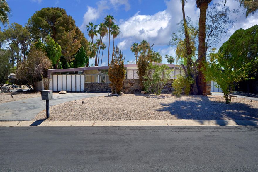 Opportunity to transform a 1957 Palmer & Krisel Mid-Century Modern corner lot residence in historical Vista Las Palmas. The property has not been on the market in over 30 years, and boasts slightly over 2800 square feet and has displays fantastic bones with covetable post and beam ceilings. Due to the sizable layout, it creates high potential to modernize to today's living while keeping the integrity of the build intact. Notable features include: expansive parking space with circular driveway including drive thru covering; direct views to the backyard upon entry; mountain vistas from the backyard; rock elements in the front, back, and fireplace; four bedrooms total with the master bedroom area having opportunity to reconfigure; abundance of glass bringing in natural light and views, and a large swimming pool. Vista Las Palmas is a premier neighborhood in Palm Springs, and is in close proximity to many dining and shopping options on Palm Canyon Drive.