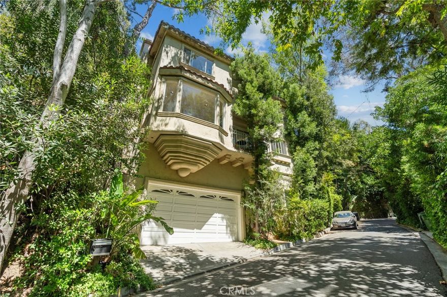 For those seeking a blend of vibrant city life and restorative canyon living, come discover the Canyon Chateau at 10055 Reevesbury Drive, the quintessential Beverly Hills sanctuary where creative inspiration thrives.



From the street, the home’s imposing façade exudes timeless European charm; its three levels, partially concealed by mature leafy trees. Inside, the journey begins in a marble-floored entry, leading to a versatile guest room/home office, bathed in natural light, full bath and convenient access to a spacious two-car garage.



The main level invites grand scale living. A great room with expansive west-facing windows framing lush hillside views, a working wood-burning fireplace and an open chef’s kitchen, ideal for entertaining while prepping meals. On this floor, a generous second bedroom with full bath and private courtyard offers a peaceful nook for reflection.



Ascend to the top level, where the heart of this creative retreat unfolds in a primary suite with soaring ceilings, gas burning fireplace, separate sitting room, and over 1,000/sf of luxurious comfort. Imagine stepping onto your private terra cotta terrace, surrounded by shade trees and vibrant landscaping. Delight in the spa-inspired marble bathroom with jetted tub, glass-enclosed shower, and two walk in closets.



Located on a tranquil street, nature enthusiasts will delight in year-round greenery and lively birdsong that enchants during morning and evening strolls. For families with children, the home enrolls to Warner Elementary, or you can tap into the Beverly Hills School system. And being just 3 miles north of Sunset, you are moments from world-class dining, shopping and nightlife options.



The next owner will want it all, canyon stillness and city energy, luxury and laidback. Discover all that and more at the Canyon Chateau where every detail is designed to inspire your daily life.