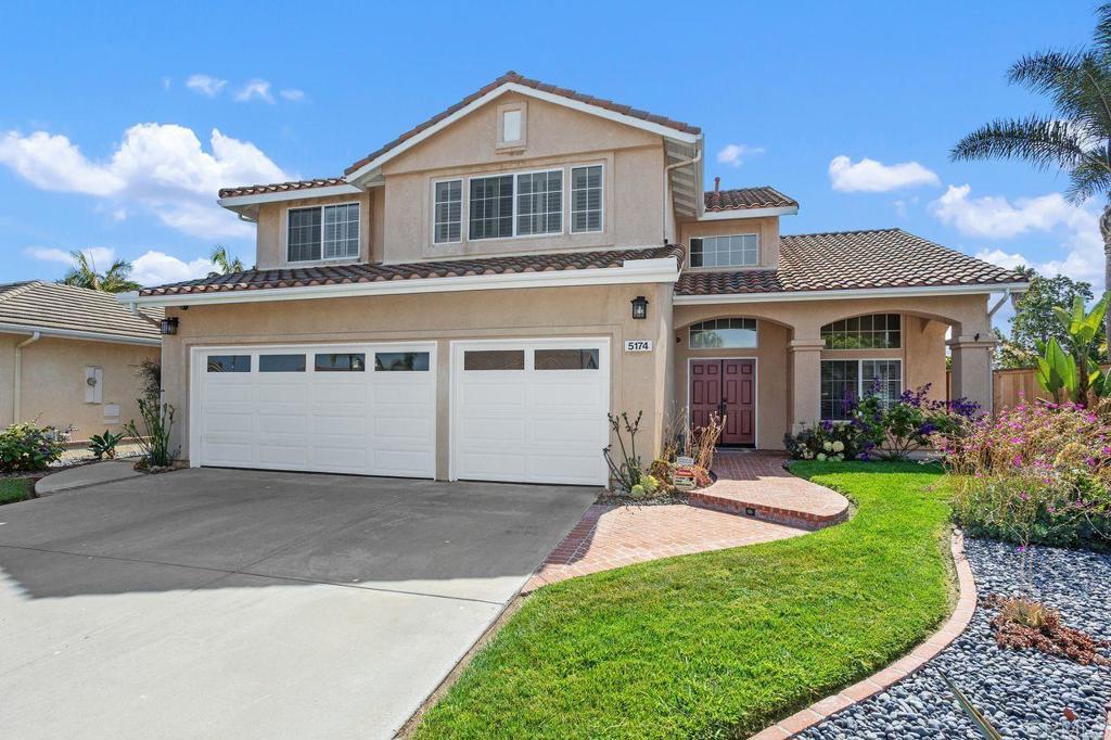 Tucked away on a quiet cul-de-sac in the sought-after Ridgeview community of Ocean Hills, this beautifully maintained 4-bedroom, 3-bath home offers an optional 5th bedroom/sitting room/office within the expansive primary suite. The ideal floor plan features soaring, vaulted ceilings, a welcoming double-door entry, and newly carpeted upstairs. The heart of the home is the kitchen with stainless steel appliances, breakfast nook, spacious pantry, center island and abundant counter space. The kitchen flows seamlessly into the family room with a cozy gas fireplace and french doors that open to a grassy, private rear yard accented with a lovely pergola—perfect for entertaining or relaxing. Enjoy a formal dining area, engineered wood flooring, plantation shutters throughout, recessed lighting, ceiling fans, and a “Quiet Cool” whole-house fan to reduce A/C usage. A downstairs bedroom and full bathroom add versatility for guests or multigenerational living. The dining room also features french door access to the backyard. The large primary suite is a true retreat, boasting a sitting room/office option, dual vanity sinks, soaking tub, separate shower, and walk-in closet. Additional highlights include a covered porch entry, separate laundry room, A/C, 3-car garage, and low HOA with no Mello-Roos. Close to Lake Calavera trails, shopping, dining, Vista Unified schools, and just minutes to beautiful beaches, this home blends comfort, style, and location.