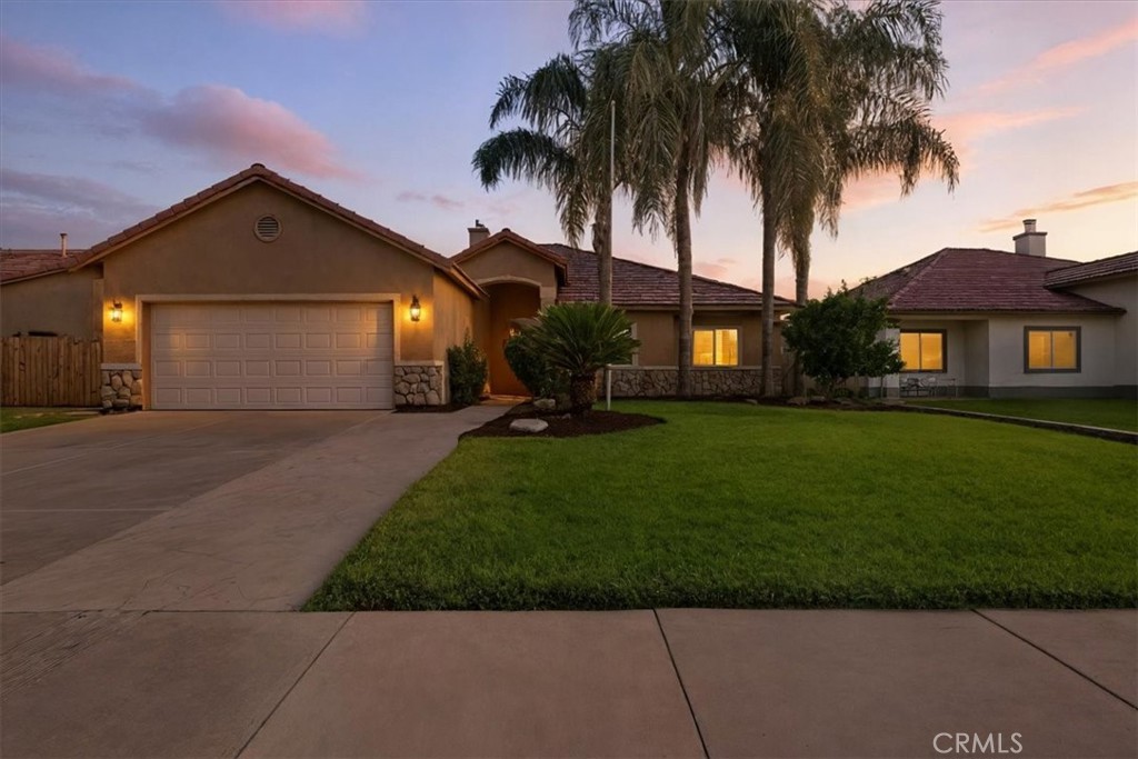 This home blends character, comfort, and style in one thoughtful design. Natural hardwood floors flow throughout the living spaces, while vaulted ceilings and a fireplace create a warm focal point in the living room. The kitchen has been updated with modern countertops, cabinetry, and stainless steel appliances, combining everyday function with timeless appeal.
The split floor plan offers privacy for the primary suite, complete with built-ins, while French doors open to a versatile bonus room that could serve as an office, retreat, or fifth bedroom. Three additional bedrooms and a full bath line the hallway, each spacious and inviting. Designer paint and a curated mix of modern and antique touches add depth and charm to every room.
Outside, a large covered patio overlooks the gated (removable) lap pool and a lush grassy area, creating a private retreat for both relaxation and entertaining. The home also features solar for energy savings, along with an assumable VA loan at approximately 3.5% interest and a monthly payment around $1,900 (including taxes and insurance)—a rare opportunity in today’s market. In a desirable Northwest Hanford neighborhood, it balances tranquility with easy access to shopping, dining, and just a short drive to NAS Lemoore