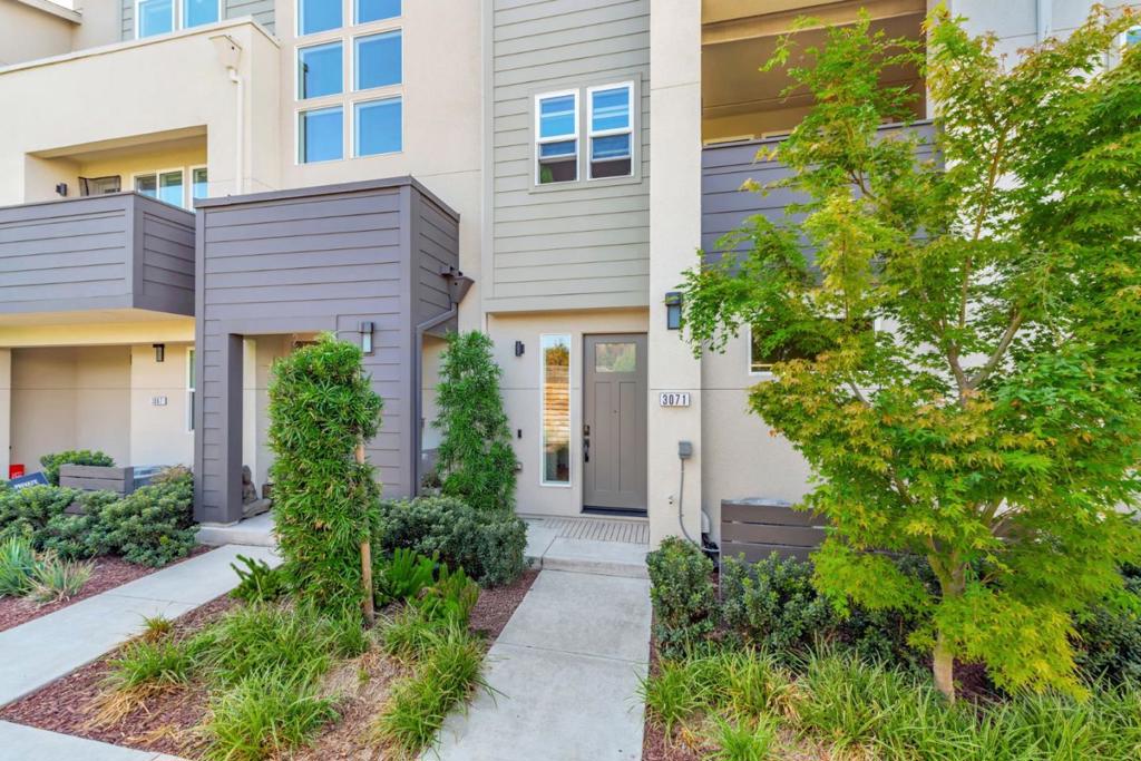 In a prime Santa Clara location, this 5-year-new townhome by award-winning SummerHill Homes occupies one of the most desirable spots in the Nuevo community. The 2BR/2.5BA home offers an open-concept great room with soaring ceilings, European white oak hardwood floors, recessed LED lighting, and a chefs kitchen with quartz slab countertops, soft-close cabinetry, and a GE Profile premium stainless steel appliance suite, all extending to a private balcony for seamless indoor-outdoor living. Two spacious en-suite bedrooms include a primary retreat with walk-in closet and dual-sink bath, while a first-floor powder room adds convenience for guests. Additional highlights include in-unit laundry, central A/C, Nest thermostat, CAT6 wiring, and an EV-ready 2-car garage. Residents enjoy resort-style amenities such as a clubhouse, dog park, playgrounds, basketball court, picnic areas, and an outdoor movie lawn. With low Santa Clara utilities and close proximity to Costco, Whole Foods, Lawrence Caltrain, and major tech employers like Apple, Nvidia, Google, and Meta with easy access to highways and public transit. This impeccably maintained home delivers modern design, everyday convenience, and community in one smart package.