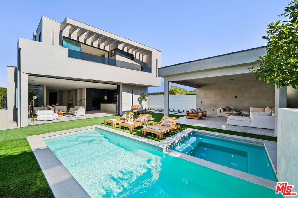 Elegantly designed, newly constructed 4 bedroom 5 bathroom architectural estate with bonus office situated in prime Beverly Grove showcasing modern technologies with an exceptional curated finish. Filled with an abundance of natural light, the open floorplan concept is complemented with its warm organic Italian stone and wide plank oak floors, high ceilings and walls of sliding glass doors that flow seamlessly into your private outdoor oasis. The beautiful master retreat redefines opulence with its showroom walk-in closet, spacious balcony and a spa-inspired master bathroom. The exceptional chefs kitchen is equipped with Miele appliances, custom reclaimed wood cabinetry and a large center island dressed in imported Italian porcelain. This home comes complete with a pool, spa, cabana, fireplace and a state-of-the-art smart home security. Extremely desirable Beverly Grove location within walking distance to The Grove, West 3rd St, The Beverly Center, Cedars Sinai and within minutes to Beverly Hills, Century City and Downtown L.A.