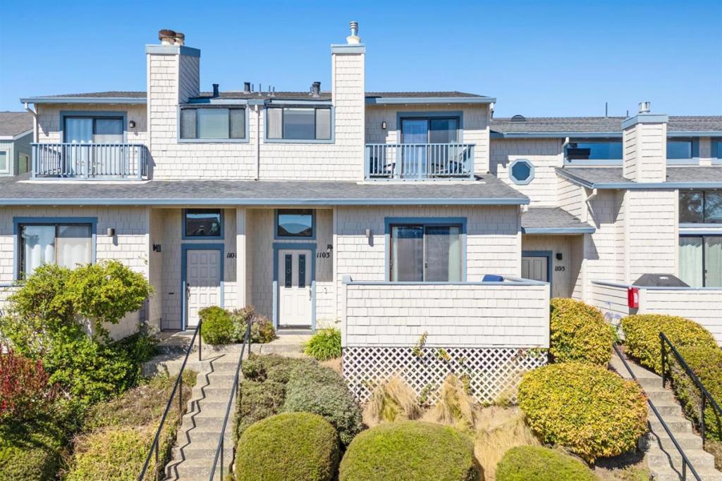 Dreaming of being just steps to the sand? Love a quiet community of beach goers? How about long walks on the beach where you can walk miles and miles with your dog? This could be just the place for you with Seascape golf course on one side and the big blue ocean on the other. This spacious 1,842 sq ft home offers three bedrooms, including a primary suite retreat, and two full bathrooms, pluse a half bath downstairs. 2 living areas creates so much separation of space it truly lives large. The gorgeous remodeled kitchen has brand new high end appliances making meal prep both stylish and convenient. Throughout the house top of the line hardwood flooring adds elegance, and the vaulted and high ceilings, complemented by skylights, enhance the open and airy atmosphere. For cozy evenings, the property features a fireplace in the living room and in the primary bedroom. Don't miss this one!