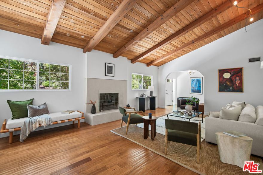 Welcome to Outpost Estates! Newly renovated three-bedroom, two-and-a-half-bath home with approximately 2,236 sq. ft. of living space on an expansive 11,600 sq. ft. lot. This home offers total serenity and privacy. The inviting living room features wood-beamed ceilings, a fireplace, and wood and Italian porcelain tile floors throughout. The newly remodeled kitchen showcases custom solid oak cabinetry, quartz countertops, top-quality appliances, large island perfect for casual dining, opening to a flexible large dining or family with access to the outdoor patio and yard. The primary suite with a remodeled bathroom featuring Italian limestone flooring, double vanities, separate tub and shower, opens directly to the lush backyard. Two additional bedrooms provide comfort and versatility and remodeled bathroom featuring modern finishes and thoughtful design. The private outdoor space includes a tranquil fountain, mature landscaping, and a grassy yard ideal for entertaining. Additional highlights include a circular driveway for easy access and a two-car garage. Move-in ready and ideally located, this home captures the best of California living in one of Los Angeles' most desirable neighborhoods. Historic Outpost Estates, this enclave is one of Los Angeles' storied neighborhoods  developed in the 1920s, it is known for its architectural character, tree-lined streets, and a close-knit community feel. You're just moments from Runyon Canyon trails, the Hollywood Bowl, the Sunset Strip, and cosmopolitan shops and dining - all while enjoying a serenity and privacy rarely found so close to the city center.
