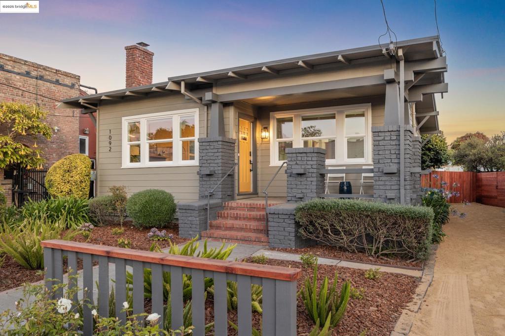 Berkeley Bungalow w/ Modern Flow, Steps from Caffe Chiave Picket fence says “modern Craftsman-style,” - Layout & upgrades say “contemporary East Bay living.” Located in highly walkable W. Berkeley, this 2-bedroom, 2-bath single-family bungalow combines timeless character w/ thoughtful updates designed for today’s lifestyle. Remodeled inside & out, the home invites you up a landscaped path to brick porch. Open-concept living, dining, & kitchen area flows seamlessly to private, low-maintenance yard w/ flexible sitting area for relaxing or secure parking pad. Office nook for additional work space off kitchen. Remodeled kitchen features SS appliances, gas range, dishwasher, breakfast bar & stacked washer/dryer. 2 well-sized bedrooms include true primary suite w/ generous closet & updated en-suite bath w/ walk-in shower. 2nd full guest bath w/ modern finishes & floating shelves. Interior details w/ engineered wood flooring throughout, dual-pane windows w/ coverings, trayed ceilings, & stylish designer lighting. Long shared driveway leads to private parking pad behind wide gate for vehiclular access. Walk & Bike Score of 93. Steps from neighborhood faves like Caffe Chiave & Lao Garden. 10-minute bike ride to Ashby BART or UC Berkeley. Not to miss! Open Sun.