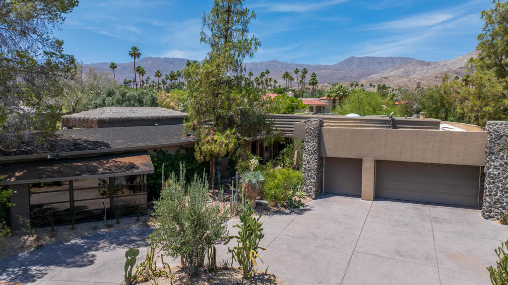 A true architectural gem, this extraordinary South Palm Desert estate is more than just a home, it's a rare piece of history. Designed by the legendary Albert Frey, this one-of-a-kind desert oasis blends timeless mid-century modern elegance with contemporary luxury across nearly an acre of prime, private land.Spanning approximately 4,600 square feet, the property features a 3-bedroom, 4-bath main residence and a fully equipped guest house. Step through the front doors into a dramatic great room adorned with original Frey stonework and a signature fireplace--an inviting space that flows seamlessly into a gourmet kitchen designed to impress even the most discerning chef.The open-concept living continues into an expansive family and game room, complemented by a custom, climate-controlled wine room that holds over 1,000 bottles. The primary suite is a private sanctuary, boasting its own fireplace, serene outdoor lounge, a spa-style bath with soaking tub, dual-entry shower, dual vanities, and an oversized walk-in closet.Designed for ultimate indoor-outdoor living, the home opens to a resort-style backyard with Frey's original pool design, lush landscaping, and a seamless flow into multiple entertainment patios all with misting systems. The guest house is a luxurious retreat of its own, complete with full kitchen, great room, fireplace, and private bedroom ideal for hosting in comfort and style.Outdoor amenities include a built-in BBQ kitchen with bar, a sparkling pool and spa, and your own putting greens with multiple tee boxes for a true golf-at-home experience.With an owned solar energy system and offered fully furnished, this property exemplifies effortless desert living. Appointments are required to truly experience the magnificence and rarity of this iconic home.