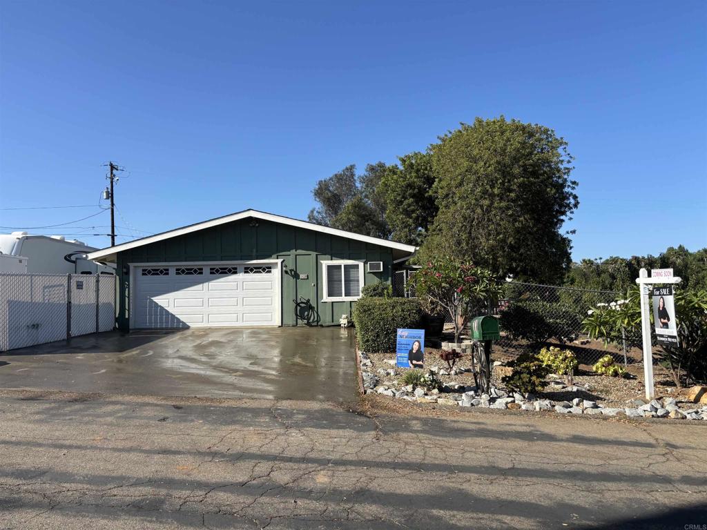 At the very end of a quiet little lane, where flowering vines climb along the fence line and mountain views stretch wide, sits a dreamy Fallbrook escape waiting just for you. This half acre sanctuary is as private as it gets, second to last on a dead end street, yet only two miles from downtown charm and just 20 minutes to Temecula’s shopping, dining, and wineries. Inside, charm meets comfort. You’ll find 2 bedrooms plus a versatile bonus room, a wide open floor plan, and a cozy wood burning fireplace. Central air conditioning, OWNED SOLAR, newer Milgard windows with a stunning bow window in the living room, and ceramic tile floors throughout make the home both practical and inviting. The kitchen is designed for both style and function with butcher block counters, double ovens, an induction cooktop, and a built-in water filtration system for fresh, clean drinking water. But step outside and the magic really unfolds. The fully fenced property is wrapped in flowering vines for privacy and bursting with life: Meyer lemon, lime, pomelo, three peach, apricot, nectarine, three plum, tangerine, orange, two avocado, two green fig, artichoke plants, many shade trees, several decorative plumeria, roses, hydrangea, hibiscus, and so much more. Raised planter beds, a drip system, and a CHICKEN COOP with run make it a gardener’s paradise. For those who love adventure, RV parking with electric, water, and septic hookups is ready and waiting. No peeking neighbors, just peace, privacy, and room to breathe. From sunrise coffee to golden hour sunsets, this property feels like a secret slice of paradise. Come wander the grounds, breathe in the fresh air, and see why this whimsical hideaway might be your perfect next chapter.