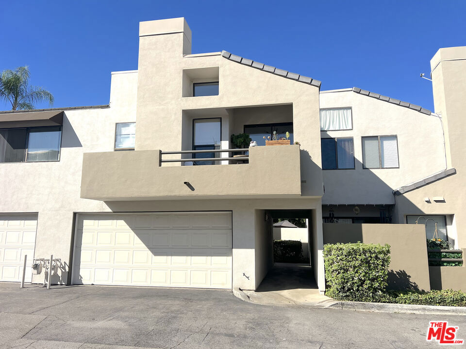 Nestled in a highly desirable Calabasas community, this beautifully updated townhome offers the perfect blend of comfort and convenience. Enjoy easy access to Malibu, local beaches, and the nearby Malibu Creek State Park ideal for hiking and mountain biking while still being just minutes from major freeways and everyday essentials. This inviting home features soaring vaulted ceilings and windows throughout, flooding the space with natural light. The cozy living room with fireplace flows seamlessly into the dining area, creating a warm, open-concept feel perfect for relaxing or entertaining. Step out onto your private balcony to enjoy morning coffee, barbecue or a dreamy summer evening. The galley-style kitchen is a cook's delight, offering abundant cabinetry, stainless steel appliances, a charming bay window, and a farmhouse sink. Recent updates include newer flooring, fresh paint, modern light fixtures, and a tastefully remodeled primary bathroom. The spacious primary suite boasts high ceilings, a large closet, and a tranquil ambiance. A generous guest bedroom and additional full bath offer space for family or guests. Practical touches include a linen closet, coat closet, and an in-unit laundry room located on the lower level with direct access to a two-car garage. The well-maintained community features a sparkling pool, spa, and BBQ area ideal for weekend gatherings or unwinding after a day on the trails. A perfect blend of comfort, location, and life style this is Calabasas living at its best.