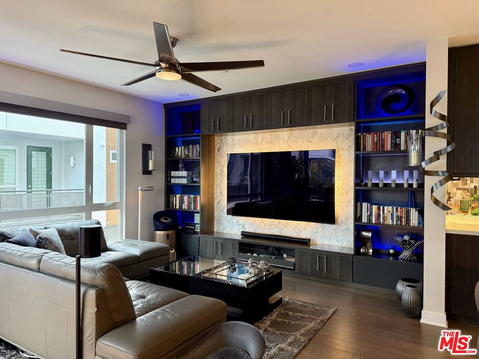 Welcome to your private Hollywood sanctuary, a rare 4-bedroom designer showpiece tucked inside the exclusive gates of Sol Hollywood. Just two blocks from West Hollywood and steps from the Sycamore District's trendiest spots, this home is more than turnkey, it's cinematic. Renovated top-to-bottom from 2021 to 2022 with no expense spared, it offers a seamless blend of elevated design, smart home innovation, and effortless indoor-outdoor living. Wake up to sunlight filtering through Lutron motorized shades, sip coffee in your metal mosaic-accented kitchen with custom cabinetry and premium appliances, then spend golden hour on your rooftop terrace beneath bistro lights, watching the Hollywood Sign catch the sunset glow. Entertain under the stars with your gas grill and fire pit, surrounded by lush planters and panoramic views of the Hills, the skyline, and even fireworks from the Bowl. Inside, every detail evokes boutique hotel luxury, from marble, mother-of-pearl, and mosaic finishes to spa-inspired baths with rainfall showers and genuine stainless steel fixtures. With 2,378 square feet of living space, nearly 900 square feet of outdoor entertaining areas, an upgraded two-car garage, whole-house water filtration, and full Apple HomeKit + Alexa integration, this home is as functional as it is fabulous. Tucked away from the street with no shared walls and direct access 2-car garage parking, it offers rare privacy and serenity in the heart of LA's most iconic neighborhood. This is not just a home; it's a statement, a retreat, a lifestyle.