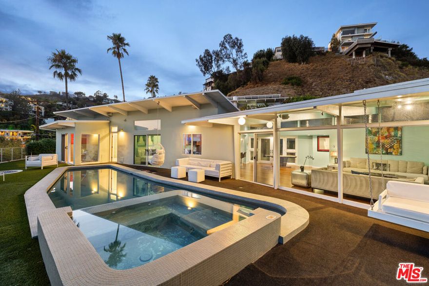 Mid-Century Modern Entertainer's Retreat! Perched above the Sunset Strip, this 3-bedroom, 2-bath mid-century masterpiece captures the best of Hollywood Hills living  panoramic city-to-ocean views, timeless design, and ultimate privacy. Flooded with natural light, the home features floor-to-ceiling glass, open living spaces, and three fireplaces that create a warm, inviting atmosphere for entertaining. The chef's kitchen with professional appliances flows seamlessly to the outdoor oasis. Saltwater pool and spa surrounded by palm trees, bamboo, and rosemary for a true resort feel. Just minutes from Soho House, Chateau Marmont, Runyon Canyon, and the Sunset Strip's iconic nightlife, this home perfectly balances tranquil seclusion and city energy.More than a home, 8411 Hollywood Blvd is a statement of style and soul  designed for those who love to entertain, unwind, and live the California dream!