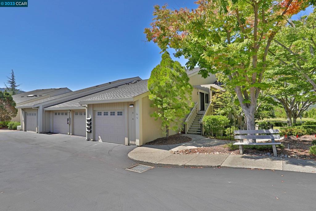 Welcome to this expanded, level-in 2 bedroom, 2 bath gem w/ peaceful hill and greenery outlook. No stairs to front door! With recent upgrades including fresh paint and luxury plank flooring, this unit exudes that desirable sense of ease and comfort. The spacious layout not only offers a large open living room facing the view, plus wood-burning fireplace, but also flex space too for office, reading, crafts or more. Primary bedroom offers retreat/office space, dual sinks, walk-in closet. The second oversized bedroom/den offers door to sweet front patio. The formal dining room combined with the bright breakfast nook provides the perfect spaces and flexibility for both formal gatherings and casual meals. More standout features of this unit include its accessibility w/ no stairs to front door, an attached garage that ensures ease of access, plus carport. Don't miss the extra storage in the garage loft.