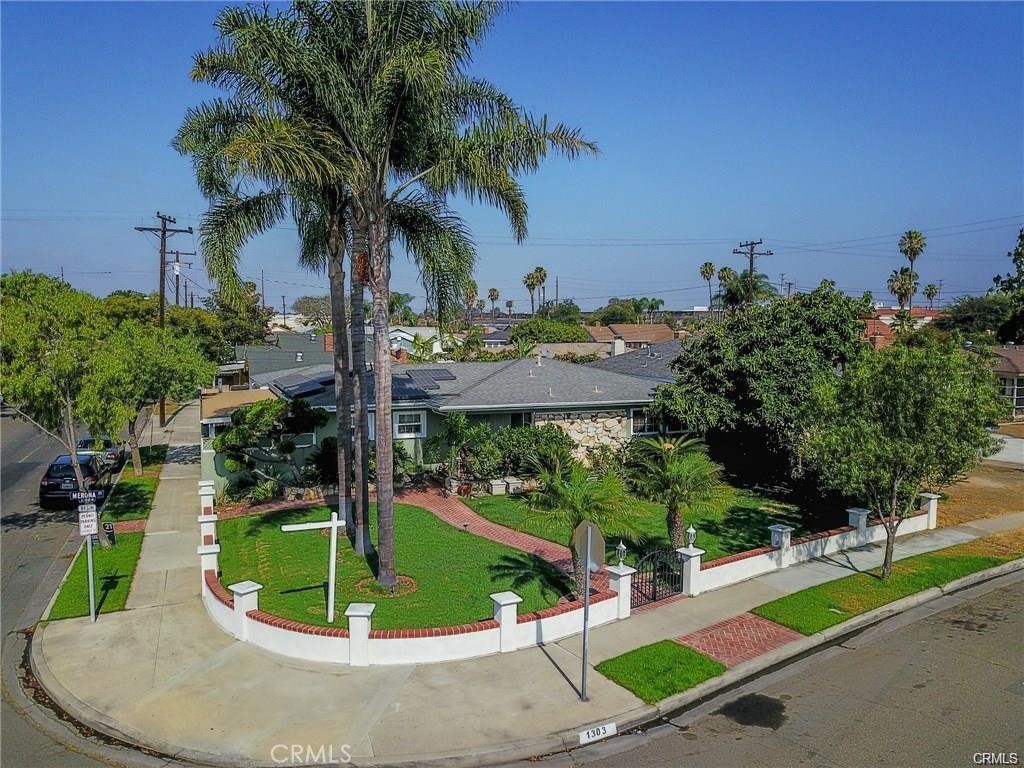 Beautiful corner lot property with lush front yard landscaping, single story, 3 bedrooms, 2 full bathrooms with a Pool! The custom pool features a waterfall that you can enjoy listening to at anytime you please. Property features a Two car garage, Fruitful Avocado tree, Solar Panels, Washer and Dryer hook ups inside and outside home. Lot features an excellent layout that allows space for extra parking if necessary for you. Property location has easy access to the 91 fwy and 57 fwy. Come see this home!