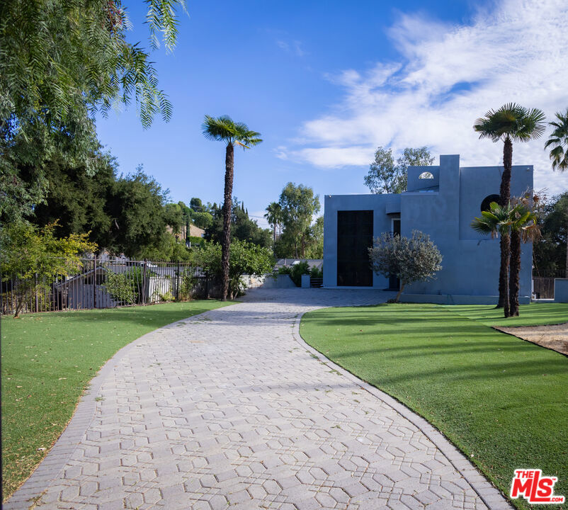 Modern Elegance in the Hills. Step into contemporary luxury in this stunning 3 story modern masterpiece located in the heart of Woodland Hills. Boasting 5 spacious bedrooms and 5 bathrooms, this home offers the perfect blend of comfort, design, and functionality. 3 of the bedrooms are private primary suites, ideal for multi-generational living or hosting guests in style.Enjoy a show-stopping indoor jacuzzi and unwind in the inviting family room with a sleek fireplace, perfect for cozy evenings or entertaining. The lower level features a dedicated billiard room or can be used as an additional family room/lounge area, offering flexible space for relaxation or recreation. Don't miss this rare opportunity to own a modern gem with room to grow in one of Woodland Hills' most sought-after neighborhoods.