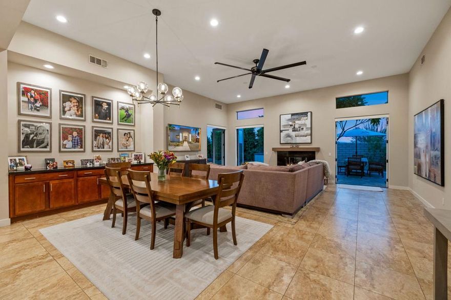 Pele Place - Palm DesertPerfectly positioned in the heart of Palm Desert, this one-of-a-kind semi-custom home blends sophistication, comfort, and modern desert style. Behind its double-door entry, soaring 12- and 10-foot ceilings and oversized tile floors create a grand sense of space. Every detail feels intentional--8-foot doors, thick baseboards, designer lighting, and French doors opening to the resort-style backyard.The open-concept living area centers around a dramatic great room with a statement fan and a stunning chandelier over the dining space. The chef's kitchen showcases granite slab counters, a custom backsplash, Bosch stainless-steel appliances, a pantry, dual sinks, and a mini wine fridge--ideal for entertaining.The primary suite is a retreat of its own with double-door entry, direct backyard access, and a spa-inspired bath featuring a free-standing soaking tub, floor-to-ceiling tile, a floating double vanity with quartz counters, and a massive walk-in shower with three shower heads.Guest bedrooms are thoughtfully placed on the opposite wing for privacy and share a beautifully appointed full bath. The garage impresses with epoxy flooring, high ceilings, and built-in cabinetry.Outside, nearly 11,000 square feet of private, cul-de-sac living awaits--complete with a custom Pebble Tec pool & spa, firepit lounge, built-in BBQ, and lush mature landscaping framed by stone decking. Modern, custom, and move-in ready--Pele Place is a true Palm Desert gem built for desert living at its finest.