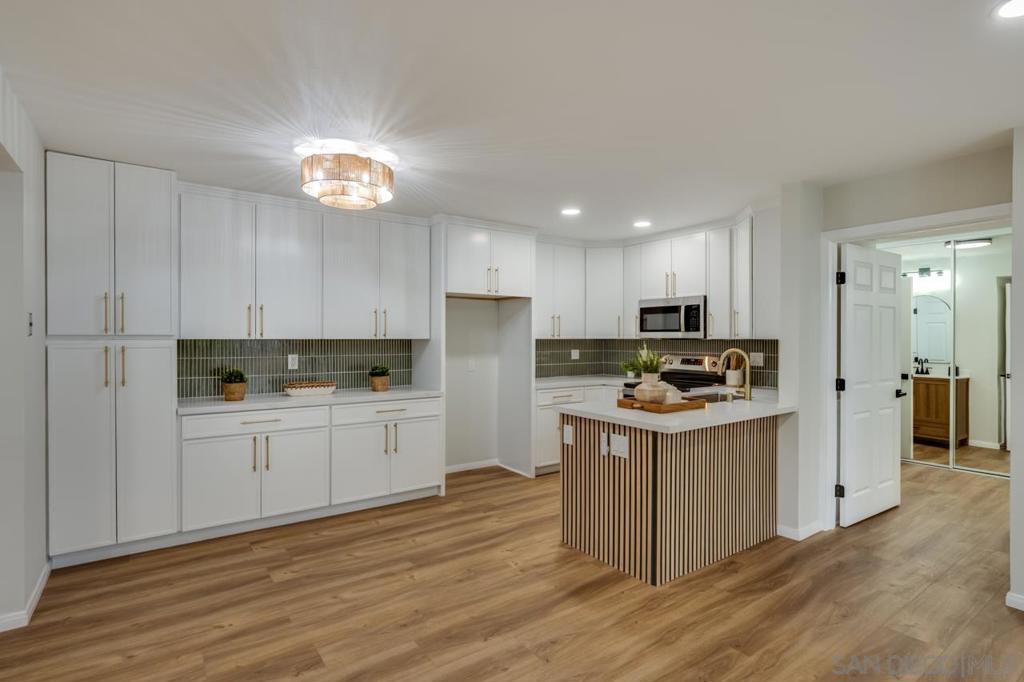 55+ Community! Step into this beautifully remodeled 2-bedroom, 2-bathroom condo that perfectly blends modern comfort with timeless style. Every detail has been thoughtfully updated, including brand-new luxury vinyl flooring, sleek kitchen cabinets, stylish tiled backsplash, and elegant countertops. The bathrooms have also been tastefully renovated with high-end finishes for a spa-like feel. Enjoy cooking in the upgraded kitchen featuring stainless steel appliances. Located in a desirable community that offers fantastic amenities including a sparkling pool and access to a golf course. This condo is in a prime location—close to shopping, dining, and entertainment. A true gem that’s move-in ready!