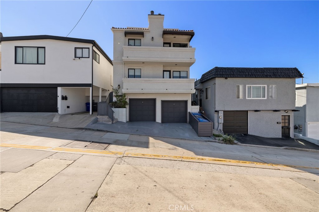 Coastal living at it's finest! Beautiful ocean views, with ample parking for 4 vehicles in the garage, with an additional 5th spot in front, will capture you as you enter this tri-level, custom and newly renovated home. Nestled just eight houses up from the strand with unobstructed whitewater views from Palos Verdes to Malibu, this El Porto residence offers the best of California's luxurious beach living with prime access to the BEST surfing in the South Bay. There's plenty of space to relax after long days of work or play in this expansive 4 bedroom, 4 bath home. The top floor includes a beautiful kitchen featuring sleek Corian countertops, premium Viking - stainless steel appliances and contemporary custom cabinetry. The large kitchen windows provide beautiful views while flooding the space with plenty of natural light. The adjacent dining room which can double as a family room includes a natural stone fireplace, accessing a deck perfectly situated for a BBQ. Also included are 2 bedrooms - the primary bedroom with access to a back balcony, and en-suite bathroom. The second bedroom sun drenched from it's westerly facing windows, provides a private hide-away access to a hidden roof-top deck. The 360 degree views, create the perfect perch with which to watch the bustling of the beach during the day, or an exquisite spot to star-gaze at night. The middle floor mimics the layout of the top floor with a more 'formal' living area featuring a second natural stone fireplace and deck. This floor also includes an office nook equipped with ample cabinetry for storage and a mini-bar area. The two remaining bedrooms also offer the same amenities as the floor above however the decking has stair access to an exit and outdoor shower below. A unique feature loved by those with large families, is the placement of laundry facilities on each floor! This exceptional home places you steps from award-winning schools, restaurants, charming boutiques and many other amazing amenities. This prime location provides commute times of just minutes to LAX, or minimizes the time to the West Side or Downtown LA dramatically! The opportunity of living the 'Manhattan Beach' lifestyle can be yours!