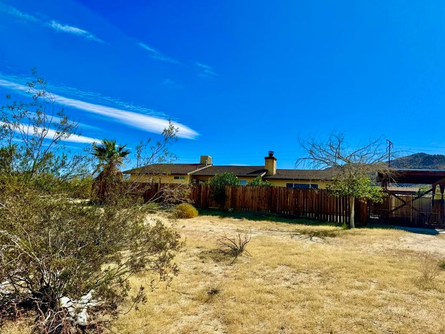 Desert Oasis on Over 1 Acre - Very close to Joshua Tree. Room to grow!!Incredible location with panoramic desert views! This meticulously maintained, one-owner home is situated on just over 1 acre, ideally located between Joshua Tree and 29 Palms. Built in 1986, this newer construction features a 2-car attached garage, covered RV parking, multiple storage sheds, and a fully fenced yard.Enjoy privacy, space, and functionality with city water, electric, septic, and propane already in place. Bonus 15x15 detached structure is ready to be transformed--perfect for a studio, workshop, or guest space.Move-in ready with tons of potential to add value and make it your own. Peaceful setting with the convenience of being close to everything--shops, schools, and Joshua Tree National Park--while feeling worlds away in your own private retreat.Don't miss this rare opportunity to own a well-kept home in a prime high-desert location. Call today for a private showing!