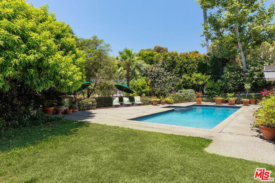 Prime City of Beverly Hills location North of Sunset! Set off the street for ultimate privacy and surrounded by mature landscaping, this single-level home is a hidden gem. The open floor plan and abundant natural light enhance the spacious feel, complemented by a separate formal dining area and a large livingroom with a fireplace and French doors that open directly to the tranquil, park-like grounds. The pool and spa are surrounded by lush gardens, and a relaxing patio space on nearly 22,000 sq. ft. of land. The newly redone chef's kitchen offers a side-by-side Sub-Zero refrigerator, 6-burner Wolf range, Miele dishwasher, Gaggenau steamer ovens, quartzite countertops, and two center islands. The kitchen opens perfectly to an eat-in breakfast and a family area. The home includes recently remodeled bathrooms, including a luxurious master bathroom and updated secondary bathrooms, with new flooring throughout. Additional features include a family room, powder room, laundry room, and separate maid's quarters. This turnkey, ready-to-move-in property offers endless possibilities.