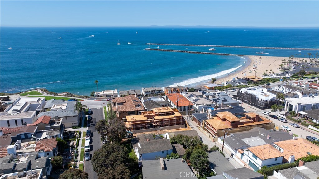 Step into coastal elegance at 209 Narcissus, a new construction opportunity in Corona del Mar’s coveted Flower Streets, designed by EBTA Architects and developed by PXG Development. Currently in framing with anticipated completion in summer 2026, this three-level residence offers a rare chance to purchase now and participate in the finishing process—allowing the buyer to personalize interior selections and create a truly bespoke coastal retreat. The home spans approximately 2,948 sq ft with four ensuite bedrooms, two 1/2 baths, and an attached two-car garage. Light-filled living spaces transition seamlessly to an elevated front patio and an upper-level deck, both ideal for entertaining with Catalina and ocean views as a backdrop. Thoughtfully designed floorplan with an elevator to all three levels, balances privacy and open gathering areas, blending modern sophistication with timeless coastal architecture. Set south of Pacific Coast Highway, this prime location places you mere steps from Big Corona Beach, celebrated tide pools, and the scenic blufftops of Lookout Point. The vibrant CdM Village is equally close, offering boutique shops, cafes, and acclaimed dining—all within walking distance. The Flower Streets are recognized as one of Southern California’s most desirable neighborhoods, with strong values supported by a mix of charming cottages, custom estates, and new builds that command premium pricing. Purchasing at this stage provides a unique advantage: secure a brand-new home in one of Orange County’s most sought-after enclaves while enjoying the ability to shape finishes to your taste. Rather than compromise on someone else’s vision, you can guide the final design of your kitchen, baths, flooring, and fixtures. Once complete, the home will deliver the effortless indoor-outdoor lifestyle Corona del Mar is renowned for, with daily ocean breezes, golden-hour views, and walkable access to village charm. Don’t miss this chance to create your personalized coastal sanctuary in an irreplaceable location—where architectural distinction, ocean proximity, and community lifestyle converge.