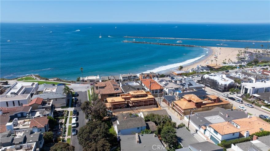 Step into coastal elegance at 209 Narcissus, a new construction opportunity in Corona del Mar’s coveted Flower Streets, designed by EBTA Architects and developed by PXG Development. Currently in framing with anticipated completion in summer 2026, this three-level residence offers a rare chance to purchase now and participate in the finishing process—allowing the buyer to personalize interior selections and create a truly bespoke coastal retreat. The home spans approximately 2,948 sq ft with four ensuite bedrooms, two 1/2 baths, and an attached two-car garage. Light-filled living spaces transition seamlessly to an elevated front patio and an upper-level deck, both ideal for entertaining with Catalina and ocean views as a backdrop. Thoughtfully designed floorplan with an elevator to all three levels, balances privacy and open gathering areas, blending modern sophistication with timeless coastal architecture. Set south of Pacific Coast Highway, this prime location places you mere steps from Big Corona Beach, celebrated tide pools, and the scenic blufftops of Lookout Point. The vibrant CdM Village is equally close, offering boutique shops, cafes, and acclaimed dining—all within walking distance. The Flower Streets are recognized as one of Southern California’s most desirable neighborhoods, with strong values supported by a mix of charming cottages, custom estates, and new builds that command premium pricing. Purchasing at this stage provides a unique advantage: secure a brand-new home in one of Orange County’s most sought-after enclaves while enjoying the ability to shape finishes to your taste. Rather than compromise on someone else’s vision, you can guide the final design of your kitchen, baths, flooring, and fixtures. Once complete, the home will deliver the effortless indoor-outdoor lifestyle Corona del Mar is renowned for, with daily ocean breezes, golden-hour views, and walkable access to village charm. Don’t miss this chance to create your personalized coastal sanctuary in an irreplaceable location—where architectural distinction, ocean proximity, and community lifestyle converge.