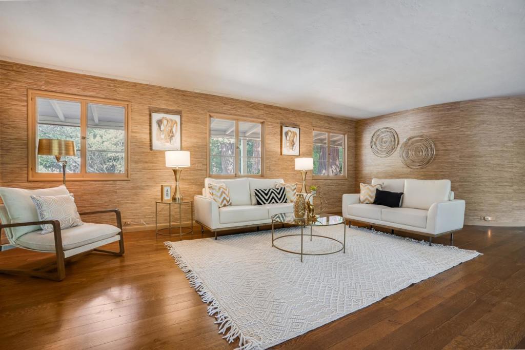 Presiding on approx 3 acres on one of Woodside's most premier streets, this is an outstanding opportunity with a wealth of possibilities. The vast level land borders a seasonal creek and is dotted with redwood groves, heritage oaks, and stretches of sun-swept open land. The classic main home exudes mid-century style, and spanned by a covered porch, plus a, newer guest house. Either home could be enjoyed as is today or while awaiting plans for remodeling or potentially building new in this fabulous setting. The treasured location offers all the privacy and rural feel for which Woodside is known, yet is just minutes to Sand Hill Road venture capital centers and Stanford University. Woodside town center is less than 2 miles away and miles of hiking, biking, and riding trails are all around, including The Horse Park at Woodside. Whether an equestrian estate, executive retreat, or family compound, this property stands ready enjoy the quintessential Woodside lifestyle.