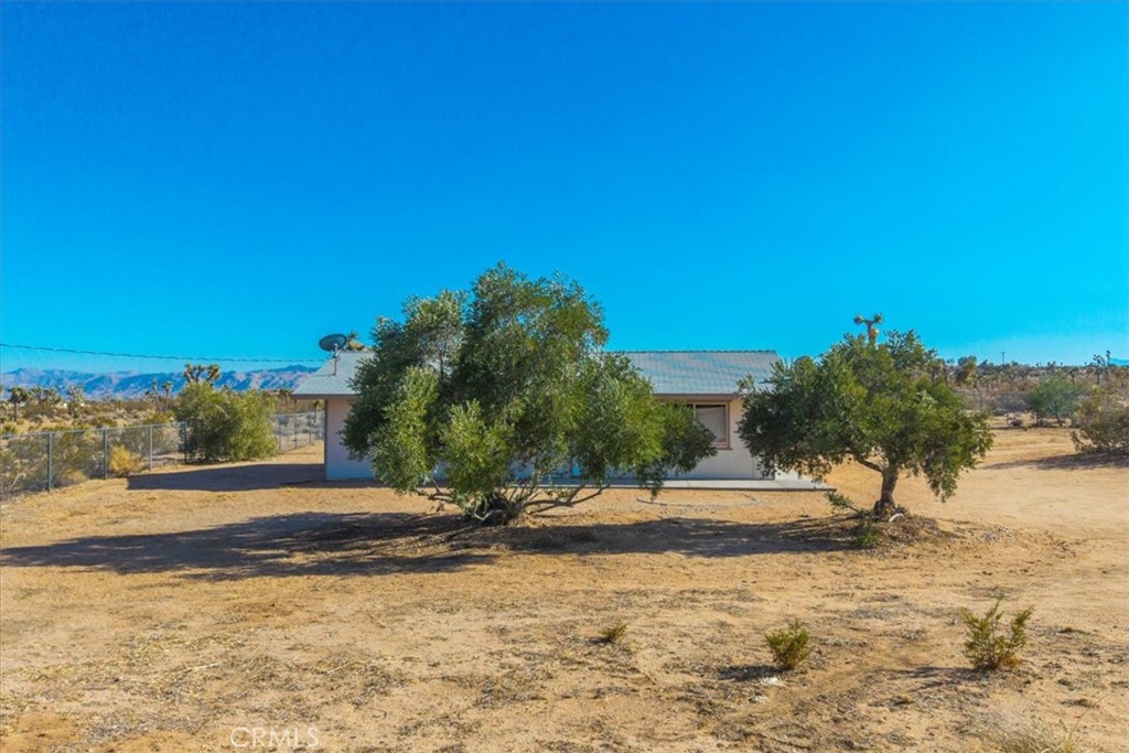 Priced To Sell! Two Bedroom One Bathroom On 3.6 Acres Boasting Sprawling Panoramic Views! Nestled on a large lot with gorgeous vistas of mountains, desert landscape, cacti, and other desert flora, this property won’t last long! Entering through the chain-link fencing that surrounds the perimeter, you are welcomed home. Upon stepping through the front door, you find an 800 sq. ft. charming desert escape built in 1939! The living area features carpeted flooring and plenty of natural light coming in from well-positioned windows that take full advantage of the views. The good-sized kitchen includes cabinets and vinyl flooring, providing ample space for you to prepare your culinary delights.
This home includes two bedrooms, both featuring carpeted flooring and nice closet space. The full bathroom is equipped with a vanity, shower, and bathtub. You will also find a lovely bonus room that would make a perfect home office! Stepping back outside, you are greeted by an ideal space for outdoor barbecues, get-togethers, or plenty of room for your creative ideas! It’s not every day that you find a property priced so well that offers so much! Call today for your private showing before this one is gone!