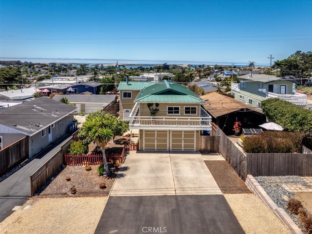 Got views? This one sure does of the mountains to the S/W, the bay, sand dunes, and the ocean. Up stairs you find a large living room with views, a franklin stove, good sized kitchen this owner choose to dine in and the primary bedroom and bath. The sliding glass door in the living room leads leads you to a 8' x 26' deck to watch those beautiful sunsets. The deck actually walks you 3/4's around the outside of the house and stairs to enter the back yard. Downstairs you'll find two more bedrooms that share the Jack & Gill 3/4 bath. Because the garage has been changed to living space you enter this area through a separate doorway. Inside you'll find a nice kitchen, living room with plenty of space for a murphy bed, and a full bathroom. In the front of the home there's room to park 5-6 cars off the street. There's a nice front yard with a fig tree, fenced in area for fido or a garden. The back yard has a covered space already wired for your hot tub, a great workshop with power, and a place for your outdoor picnic table and firepit. The covered storage spaces around the outside of this home are unbelievable. For those thinking, but I don't have a garage for my stuff, you might be pleasantly surprised at how much storage there is. A new forced air gas furnace has just been installed.