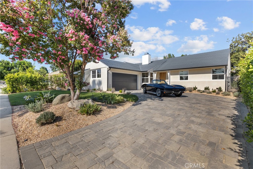 A beautifully reimagined blend of modern design and classic ranch charm, this fully remodeled 4-bedroom, 2-bathroom home is located in a quiet, tree-lined pocket of Lake Balboa. Originally built in 1956 and thoughtfully transformed, the home now offers a bright, open layout with stylish finishes and a seamless indoor-outdoor flow.
The spacious living room is anchored by a sleek double-sided fireplace and opens to the dining area and a newly updated kitchen featuring custom cabinetry, quartz countertops, and stainless steel appliances. French doors lead to a generous covered patio and expansive grassy yard—perfect for entertaining or relaxing in the California sun.
The versatile floor plan includes a dedicated den or flex space with built-ins, and the expanded 2-car garage, once used as an artist’s studio, offers incredible natural light with its north-facing skylights—ideal for creative work, a gym, or ADU potential.
Set on a generous lot in a sought-after neighborhood close to parks, schools, and freeways, this home is the perfect balance of style, function, and location.