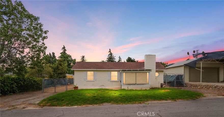 Price improvement! Single story home with a detached garage on a .25 acre flat lot with alley access! Located less than .5 miles from Uptown Yucaipa classics like White Rabbit Coffee and Brewcaipa, this home is an excellent example of classic Yucaipa charm in a great location.  Enter through the front screened porch into the living room, where you'll find plenty of natural light and vaulted ceilings with exposed beams.  A sizable bedroom has direct access to the full bathroom.  The large kitchen features eat in dining.  A smaller bedroom off to the side would also make a great home office.  Heading out back, you'll find access to a sizable cellar - perfect for long term storage.  There is a detached one car garage as well.  The sizable, flat lot has great alley access.  Great potential to build a large garage or shop, or even an ADU with it's own access! The home has new carpets throughout and fresh interior paint.