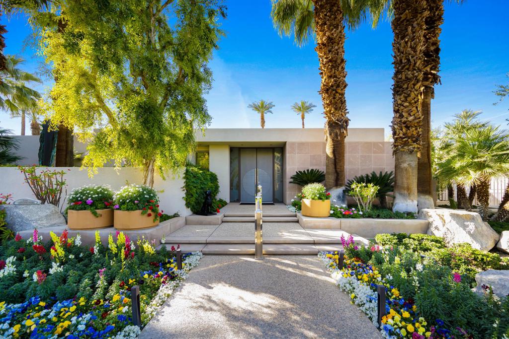 Sleek, private and exceptionally appointed, this contemporary Holden and Johnson architectural showplace is located off-fairway at the exclusive guard-gated enclave of Eldorado Country Club in Indian Wells. Crafted in 1998, the expansive custom residence extends approx. 9,114 s.f. and reveals 5 ensuite bedrooms and 6.5 baths, including a self-contained apartment with separate entrance. High ceilings, stone tile, wood accents, mitered frameless windows, granite fireplaces, full-service wet bars and unparalleled views of Eisenhower Mountain are enjoyed throughout the home, which reveals open living and dining rooms, a chef-caliber kitchen and more on the main level. Primed for entertaining, the lower floor impresses with a movie theater, game/party room with large bar, a wine cellar and tasting room, a gym, sauna, and a hobby room with generous built-in storage. A grand staircase and an elevator serve both levels. A private resort ambiance is enjoyed on a premium corner homesite embellished with a pool, spa, built-in seating area with open-air fireplace, a built-in kitchen with grill, gorgeous landscaping, a dog run, sun and shade patios and a garage with parking for 6+ vehicles.