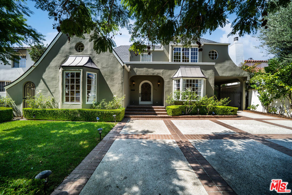 This character-filled home, located on one of the best streets in South Beverly Hills, combines classic style with comfortable living. The front entry opens to a bright living room with vaulted ceilings and a fireplace. A formal dining room with French doors leads to the backyard, creating an easy flow for gatherings. The kitchen features granite countertops, stainless steel appliances, and plenty of storage, and connects to a casual family room. Upstairs, the primary suite offers vaulted ceilings, a sitting area, and access to a private balcony. Additional bedrooms provide space for family, guests, or a home office. The backyard includes a brick patio with fountain, landscaped greenery, and multiple seating areas. With thoughtful details and a functional layout, this home offers close proximity to world-class shopping, amazing restaurants, and places of worship.