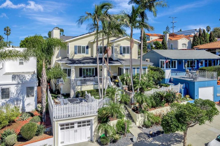 Experience coastal luxury perched overlooking the Pacific Ocean from your two beautifully designed homes. The front home features approximately 2,358 sq. ft., boasting four bedrooms and three bathrooms with a flexible floor plan ideal for multi-generational living or work-from-home flexibility.  Upstairs, the expansive primary suite offers serenity and refined comfort, complete with a soaking tub, steam shower, dual sinks, abundant bespoke storage abounds, two primary closets, a dedicated shoe closet, and more storage cabinetry.  A bonus office/bedroom sits nearby, creating the perfect retreat for relaxation or productivity or use it as a bedroom.  All with ocean views! The main level highlights two bedrooms and two baths, a cozy formal living room, a spacious great room, and a recently remodeled chef’s kitchen equipped with a GE Profile column refrigerator and freezer, Viking range and hood, marble countertops, double-drawer Fisher & Paykel dishwasher, and 25-lb. ice maker. There's even a trash compactor.  Meticulous craftsmanship is evident throughout — from the true inset cabinetry and hidden drawers to the thoughtful appliance garages and designer finishes.  Luxury continues outdoors with a saltwater pool and spa surrounded by new turf and 2024 drainage upgrades. A dry bar with dual beverage refrigerators in the great room and a full laundry room open directly to this resort-style space. Three gas fireplaces—including one at the foot of the primary bed—add warmth and ambiance throughout the home.  The front home is powered by 40 solar panels (PPA approx. $0.20/kWh, transferrable) is served by private parking in a two-car garage, plus an additional one-car garage.  At the rear of the property, on the alley, is a separate two-bedroom, one-bath second home (approx. 899 sq. ft.) above a three-car garage, currently leased for $4,395/month. This second home features a newly remodeled bathroom (2025) and refreshed kitchen (2024) with new counters, sink and more.  Updated garages include brand-new epoxy floors, slat walls, stainless sinks, and custom storage, with an EV charger serving the main residence.  Additional highlights include a movie/playroom beneath the main home, ideal for guests or family entertainment, and an ocean-view deck above the front garage showcasing stunning sunsets. Recent upgrades include a 2025 water heater with recirculating system, as well as a whole-home water softener and filtration system. This is a smart home with wifi controls of lighting, the pool, heating, video, door locks, appliances and more!  Some sprinklers out front on a drip system, but low water usage with turf and low water usage plants.  This exceptional dual-home property combines craftsmanship, design, and effortless coastal living — a rare opportunity in Ocean Beach.