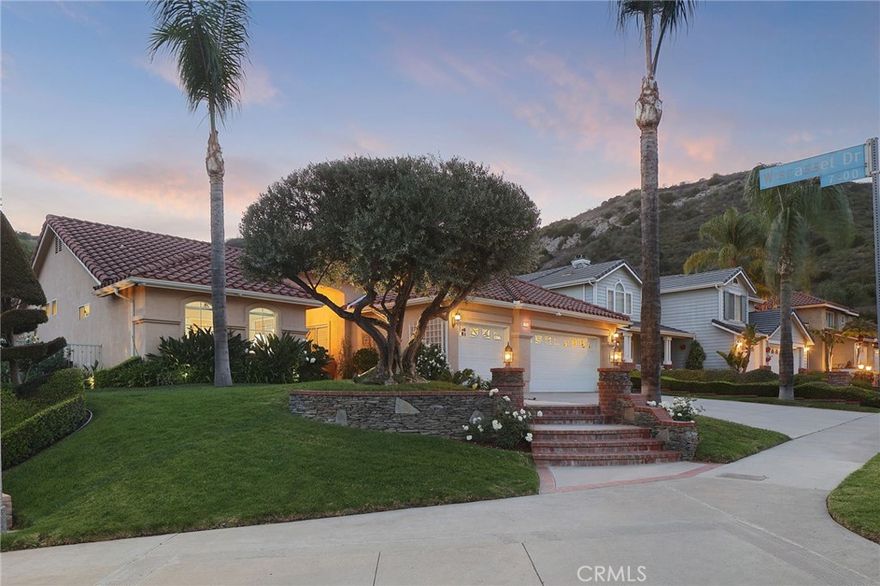 PRICE ADJUSTMENT!!Exquisite  redone single story home, ideally situated on a corner lot in the highly sought after "Stonegate Community" of West Hills. Resort style living. Enter through the double doors into a spaious living room with vaulted ceilings. Expansive windows and doors that through which the rooms are flooded with natural light. The chef's kitchen is the heart of the home, complete with a large center island, granite countertops, and newer stainless steel appliances. It seamlessly flows into the inviting family room where a cozy fireplace and wine refrigerator sets the perfect ambiance. The true primary suite is a peaceful retreat with lofted ceilings, a generous walk-in closet, and a spa-like en-suite bathroom featuring dual vanities, a soaking tub, separate shower-all overlooking the beautifully landscaped gardens. Thoughtfully upgraded and meticulously maintained, the home also offers three additional bedrooms and two full bathrooms, ideal for family or guests.  Step outside to your own private oasis, lushly landscaped grounds, two expansive covered patios with skylights and a ceiling fan, a built-in BBQ, and a stunning pebble tec pool and spa with cascading waterfalls.  Enjoy serene views of the surrounding hill and an abundance of fruit trees, creating the perfect setting for both relaxation and entertaining. Located within the prestigious school district for Pomelo,, Hale, and El Camino School, and just minutes from Warner Center, Westfield Topanga, The Village, Calabasas Commons, top-tier shopping, parks, and scenic hiking trails-this home truly has it all!