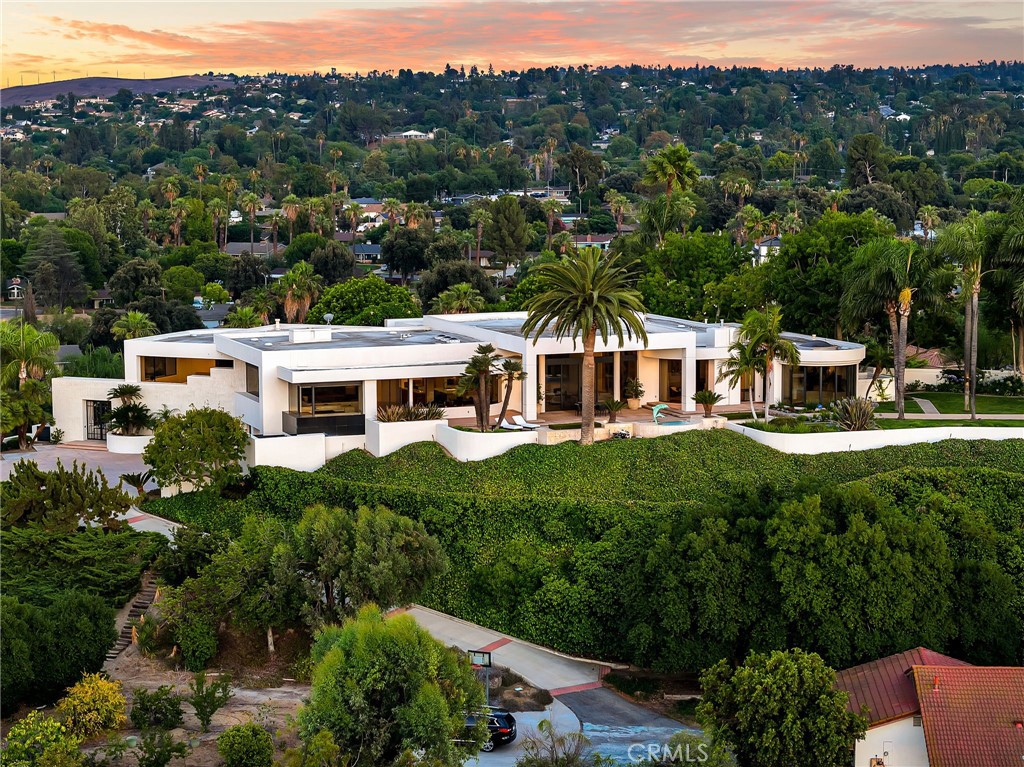 Welcome to the pinnacle of luxury living at 2130 Old Quarry Road, nestled in the prestigious enclave of Victoria Woods, Riverside, CA. Perched atop a private hill, this architectural masterpiece offers over 9,252 square feet of refined elegance, unmatched privacy, and sweeping 360-degree panoramic views. Fresh off an over two year comprehensive multi-million dollar transformation of finishes and systems resulting in an effectively brand new state of the art property!
A true sanctuary, this estate masterfully blends contemporary design, high-end finishes, and resort-style amenities to create an atmosphere of quiet grandeur. From the entrance, you're greeted by a show-stopping, one-of-a-kind natural stone fireplace—a centerpiece that sets the tone for the sophisticated interiors beyond. The home showcases exquisite details including Rosa Onyx, Botanic Crystal Quartzite, Lasa Gold, custom oak millwork, and wide-plank French Oak flooring.
Designed for elevated living and effortless entertaining, this estate includes multiple indoor bars, a wine bar, entertainment areas, and a spa-quality primary suite with a dual-entry bath, steam room, private bar, and spectacular views. The gourmet chef’s kitchen features Sub-Zero, Wolf, and Cove appliances, plus a commercial-grade exhaust system. An elegant family room with multiple seating areas and a corner bar offers an inviting ambiance.
The property is equipped with Crestron Smart Home automation, an elevator, and a full house water filtration system (SpringWell). Nearly every room enjoys stunning natural light and breathtaking vistas, enhancing the home’s seamless connection to the outdoors.
Step outside to your private oasis featuring a resort-style pool, alfresco dining, and intimate gathering spaces—perfect for sunset entertaining or peaceful relaxation. Additional amenities include a garage, washer/dryer in the unit, air conditioning, private outdoor space, parking included, and guest parking.
This is more than a home—it’s an experience of timeless luxury and tranquility, unmatched anywhere else in Riverside.