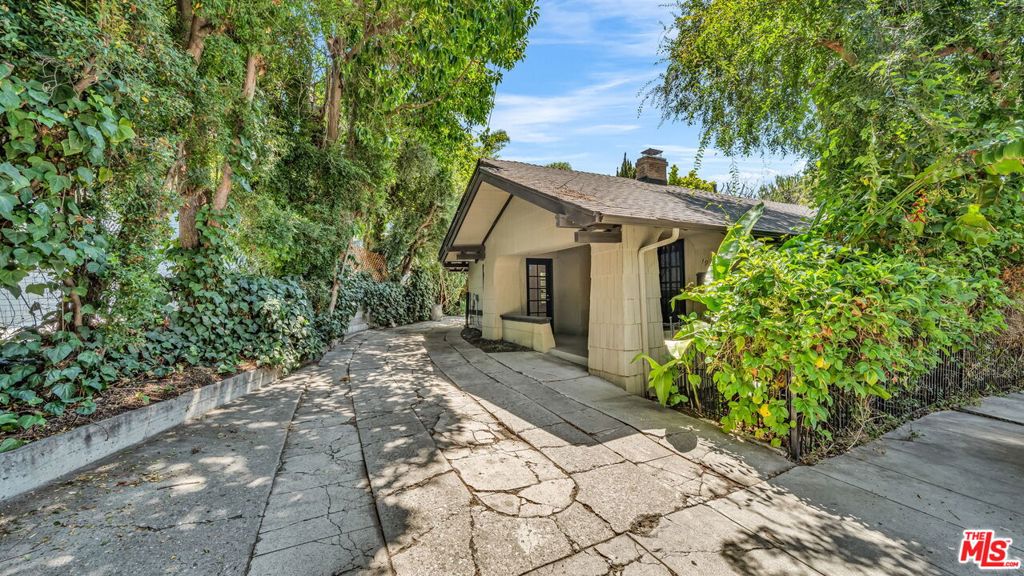 Beautifully Restored Craftsman single level home right next to a private park. This 2bed 2bath house is almost 1300sq feet with a private patio shaded by mature plants and trees. Featuring hardwood floors and original details throughout, this home has an updated kitchen, original fireplace, and separate laundry room. The large windows throughout the home offer plenty of natural light and an additional golden glow during the sunset hours. The primary bedroom has an ensuite bathroom with tub/shower and direct access to the rear private patio area. The 2nd bedroom has a direct access door to the front covered patio. Enjoy this classic, quiet and serene property steps away from the Magic Castle, Yamashiro, Grauman's Chinese Theater and the Hollywood Bowl! PET FRIENDLY