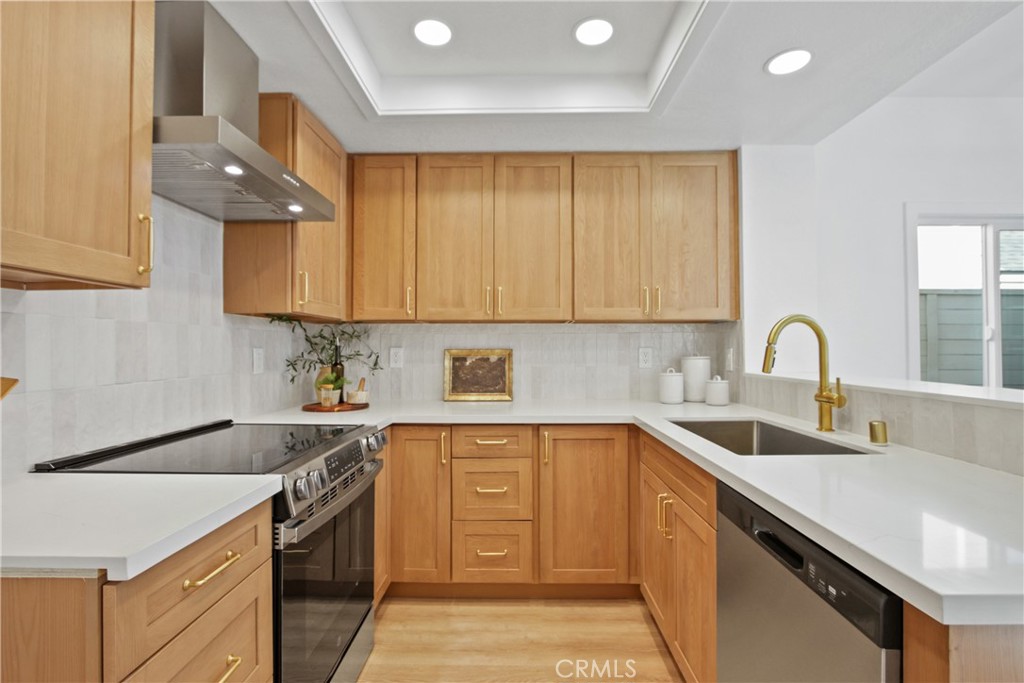 Stylish Living in the Heart of Mission Viejo! Welcome to your beautifully remodeled sanctuary where modern design meets everyday comfort. Step inside and be greeted by luxury vinyl plank flooring that stretches gracefully throughout the home, setting the stage for effortless elegance. The chef’s kitchen shines with warm wood-tone cabinetry, dazzling quartz countertops, and brand-new stainless steel appliances—including a sleek slide-in stove with range hood. It’s a space that begs for both gourmet cooking and lively conversation. Soaring vaulted ceilings and walls of windows bathe the living areas in natural light, while a cozy fireplace adds just the right touch of warmth and charm. Retreat to your primary suite oasis, featuring a spa-inspired bath with a custom tiled shower and champagne-gold finishes. Step outside to your spacious backyard, freshly laid with lush green sod—ideal for entertaining, unwinding, or enjoying a sunny California afternoon. And when you’re ready to explore, a nearby trail leads you right to Eastbrook Park, Includes access to beautiful Lake Mission Viejo with it's sandy beaches, paddle boarding and MORE! Making it easy to embrace the outdoor lifestyle Mission Viejo is known for. This is more than a home—it’s a lifestyle upgrade waiting for you.