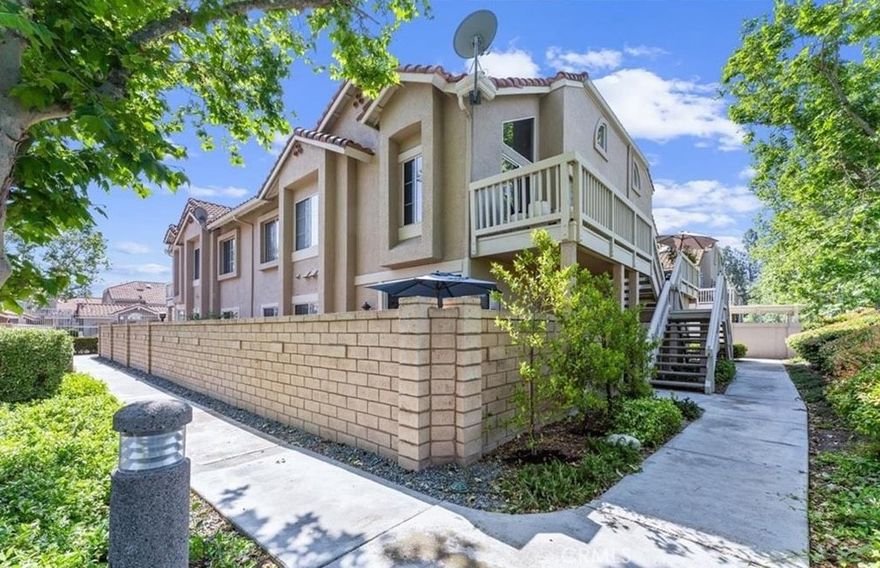 Wait, a condo with DIRECT GARAGE ACCESS that's oversized and EV-ready with room for storage? This condo understood the assignment! This charming lower-level unit sits at the end of the building and is ideal for those seeking a quieter and more peaceful living environment. The layout provides a sense of separation rarely found in attached homes and offers a very large outside patio and living space, this home lives like a private retreat. 

Step inside to an inviting open-concept living space, where natural light highlights recessed lighting, a gas fireplace, and neutral finishes that create a warm, airy atmosphere. The kitchen is thoughtfully updated with granite countertops, stainless steel appliances, and a gas range—a perfect setup for both everyday meals and special gatherings. Whether cooking for one or many, the space flows beautifully into the living room for seamless everyday living. Both bedrooms are located on the same level for ease and accessibility. The primary suite offers a calm and cozy escape, complete with a private en-suite bathroom featuring a dual vanity and walk-in shower. The second bedroom is perfect for guests, a home office, or a creative studio and is served by a full bathroom with a tub-shower combo. Just off the kitchen and living area, a sliding glass door opens to your own private patio, ideal for grilling, entertaining, or enjoying peaceful moments with a coffee in hand. For added convenience, the home features in-unit laundry, central heat and A/C, and a direct-access one-car garage with built-in storage and nearby guest parking—offering practicality without sacrificing comfort. Living in Portola Hills means enjoying resort-style amenities like a pool, spa, greenbelts, and direct access to miles of hiking and biking trails that weave through the surrounding canyons and nature preserves. All of this within the highly acclaimed Saddleback Valley Unified School District and just minutes to shopping, dining, and major commuter routes. Don’t miss this opportunity to live in one of Lake Forest's most peaceful and picturesque communities.