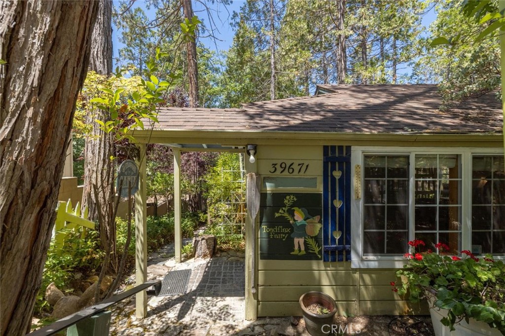 This charming cabin is located on a quiet corner lot in Bass Lake.Tucked away on a quiet street in a great Bass Lake. Included is a highly sought after boat slip on Briar Dock, This property is ideal for weekend getaways, family vacations, or a successful vacation rental.The kitchen was remodeled in 2015, including an authentic timber bar top. (Seller has full architectural plans for entire remodel, including second story addition and bump out.) Step outside to the approximately 600 square foot deck, perfect for relaxing, entertaining, and enjoying the fresh mountain air. There's also a hot and cold outdoor shower, great for rinsing off after a day on the lake.Additional features include under-house storage with electricity, ample outdoor space, and a peaceful setting just minutes from the water. Full of charm, functionality, and potential, this cabinlovingly known as The Fairy Houseis your chance to own a piece of Bass Lake paradise.