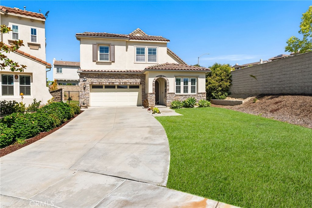 Tucked away on a peaceful cul-de-sac in the coveted Preserve neighborhood of Yorba Linda’s prestigious Vista Del Verde community, 3913 Congressional Court offers the perfect blend of timeless elegance, flexible living, and exceptional outdoor potential—with no Mello Roos and no HOA dues. Situated on the largest lot in the community—spanning over 8,500 sq ft of professionally landscaped privacy—this beautifully appointed 4-bedroom, 2.5-bathroom residence boasts 2,587 sq ft of thoughtfully designed living space, ideal for modern comfort and seamless entertaining. Step into the inviting formal living room, where calming coastal tones and custom cabinetry niches create a serene welcome. The gourmet granite kitchen is a chef’s dream, featuring a large eat-in island, generous prep space, and premium stainless steel appliances—perfect for both daily living and special gatherings. The dining area flows effortlessly into a spacious family room enhanced by a custom-built entertainment center and designer lighting—bringing open-concept living to life. A convenient downstairs bedroom with an adjacent full bath provides versatile space for guests, multi-generational living, or a home office. Upstairs, the expansive primary suite serves as a true retreat, complete with dual vanities, soaking tub, walk-in shower, and a stunning custom-built walk-in closet. Two additional well-sized bedrooms, a full bathroom, and an upstairs laundry room with a utility sink round out the second level. Step outside into your private backyard oasis—brimming with possibilities. Whether you envision a resort-style pool, lush garden sanctuary, or a family-friendly play area, the space invites you to create your dream outdoor haven. Perfectly located near Black Gold Golf Club, Yorba Linda Town Center, and within the boundaries of top-rated Yorba Linda High School, this exceptional home is a rare opportunity to own a spacious, versatile property in one of Orange County’s most desirable communities.