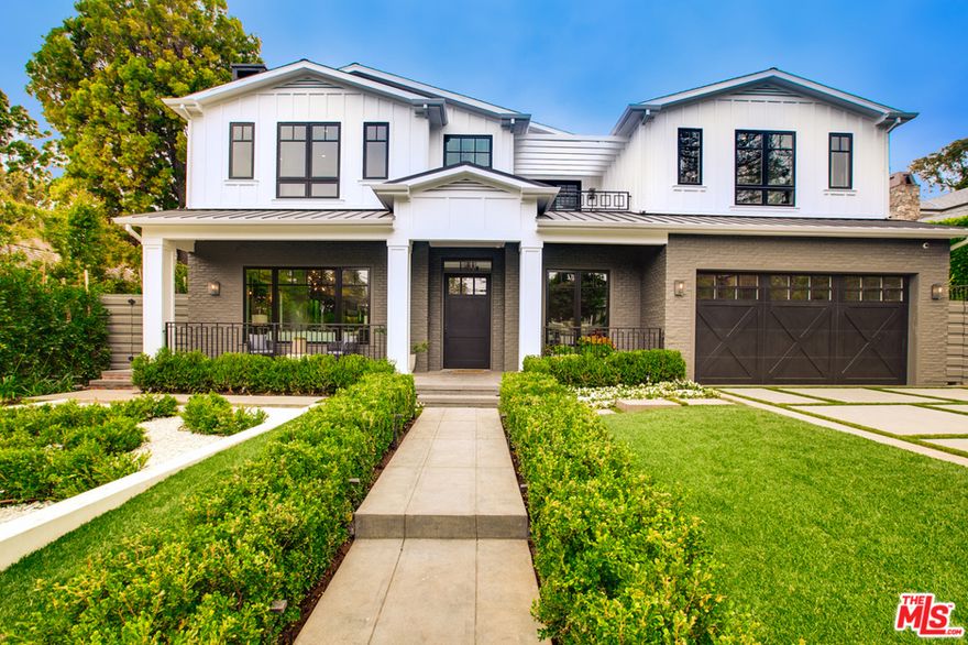 Spectacular brand new modern farmhouse residence walking distance to Brentwood Village. This Luxurious 3-story bright home offers 6 bedrooms, 8 baths, library, formal living and incredible chef's kitchen with SubZero and Wolf appliances open to family room. The seamless pocket doors off family room combine indoor outdoor space and open to the expansive backyard with sparkling heated  pool with spa, BBQ, fire pit and a large grassy area. Spacious master suite features fireplace, sizable terrace, large walk-in closet, and oversized master bath with steam and soaking tub. Five additional bedrooms are all en suite. Completely gated and private front yard . The lower level consists of a movie theatre, gym, entertaining bar and a 333 bottle wine cellar. A home elevator adds an element of ultimate convenience to an already fascinating living space. Smart system controls all lighting, security and surround sound. A true retreat in the heart of Brentwood.