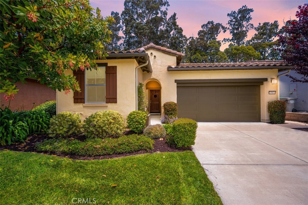 Serenity awaits in this charming 2 bedroom, 2 bath, plus flex space, Zaca Home, with a private garden oasis nestled amongst the soaring Eucalyptus. Upon entering, you will quickly appreciate the 1429 sq. ft. of well-designed, open concept living space. This move-in ready solar home, built in 2014,
features stunning sand colored wood flooring and neutral window shades, making the main living area light, bright, and very inviting. Starting in the
kitchen, you’ll love the granite island and countertops, gas range with a dramatic tile backsplash, plentiful rich maple cabinetry, and walk-in pantry.
Across the way is the flex space (which could also be used as a formal dining room or den); overlooking the kitchen is the great room with space for both dining and relaxing - featuring in-ceiling surround sound speakers, ceiling fan, a 60-inch flat screen TV and sweeping backyard views. Head out the slider to the covered patio and feast your eyes on the beautiful landscaping before you - every inch is thoughtfully designed with a sensational array of shrubs, flowering plants and trees which give it an air of peace and tranquility. The roomy covered patio is the perfect place to relax with family and friends, sip wine, or dine al fresco. Back inside, your private retreat awaits in the Primary suite with a spacious Primary bedroom overlooking the backyard paradise, and a Primary bath with granite countertop, tile floors, a beautifully tiled shower with frameless glass enclosure, linen storage closet, and a walk-in closet with full-length mirrored door. Up front is your private guest wing with a bright, roomy bedroom, a full bath with tile floor, granite countertop sink and shower/tub combo with rain glass enclosure. In addition, there’s a separate laundry room with upper storage cabinets, and a 2-car garage updated with epoxy flooring and a Level 2 electric car charger. Best of all, this delightful home is located in Trilogy with spectacular resort-style amenities, just minutes away, including Sandalwood Spa, Adelina’s Bistro, The Marketplace, and Monarch Dunes Golf Course.