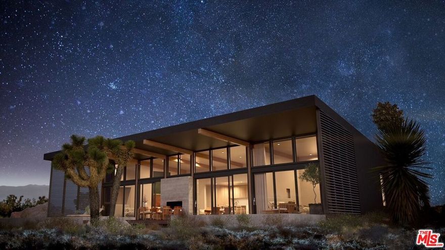 Pre-sale opportunity with an expected completion of Spring 2026. Experience the perfect blend of modern luxury and desert serenity just minutes from the breathtaking landscapes of Joshua Tree National Park. This stunning new home with a detached ADU sits on 2.27 expansive acres, offering uninterrupted panoramic views of the peaceful surroundings, including head-on views of Goat Mountain. The property features a 1,442 sq. ft. main residence with three bedrooms and three bathrooms, designed for seamless indoor-outdoor living. Soaring 16-foot ceilings and floor-to-ceiling glass walls create an airy, open atmosphere that brings the beauty of the desert inside. The sleek chef's kitchen boasts premium oak cabinetry and Caesarstone countertops, offering both style and functionality. A 690 sq. ft. detached ADU provides additional living space, perfect for guests, a home office, or an income-generating rental. A breezeway carport elegantly connects the two structures, offering shaded parking and architectural cohesion. Step outside and unwind in your private oasis, complete with a sparkling pool, a soothing spa, and a cozy fire pit, perfect for stargazing and peaceful desert nights. Located close to La Copine, Pappy & Harriet's, and top off-road adventure spots, including Sand to Snow National Monument and King of the Hammers, this home offers a prime location for both relaxation and recreation. Don't miss this exclusive pre-sale opportunity to own a one-of-a-kind desert retreat. This property also qualifies for Opportunity Zone benefits.