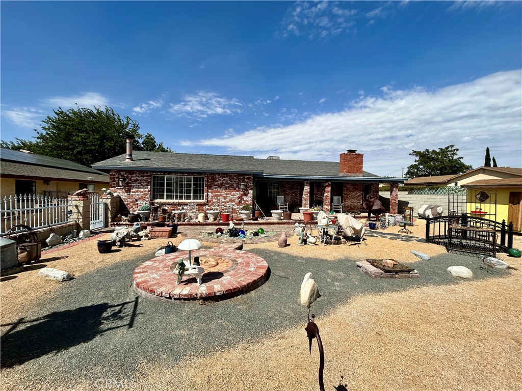 Welcome to Your Dream Home with Endless Possibilities! Nestled on a nearly quarter-acre lot, this spacious single-story gem offers 2,175 square feet of comfortable living. With RV access, a two-car attached garage, and a large covered RV space, it’s perfect for adventurers and hobbyists alike. Inside you'll find 3 generous bedrooms plus a versatile flex room ideal as a den, home gym, or creative studio. There is an expansive living room featuring a wood burning stove and built-in bar perfect for entertaining family and friends. The well appointed kitchen includes abundant cabinetry, granite-topped center island with cooktop and vegetable sink, and a breakfast nook for casual meals. Adjacent to the kitchen is a dedicated dining room for hosting memorable dinners. The backyard includes Mulberry, Crab Apple, Pear trees. There is a barn toward the back of the property with a loft space, great for storage, hobbies or rustic retreat. There are also grape vines, asparagus vines and artichoke bush for the gardening enthusiast. The private front yard includes a fire pit and charming yellow shed. This property truly has it all—space, style, and soul. Whether you're looking to settle in or expand your vision, this home is ready to welcome you!
