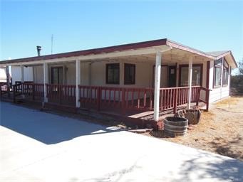 A must see to believe opportunity. This High Desert Oasis Property is a fantastic blank page of opportunity for an investor, or a new family with a creative mind. This home is a 2 bedroom 2 bath double wide manufactured home with a formal living room and dining room, indoor laundry, family room and fireplace. Large two story 4 car garage/Barn with upper loft unfinished(Ask me about this) . Many locations for animals and sheds. .This property is on 2 1/2 acres of fat usable land. The 2 story barn offers a fantastic opportunity to turn this property into an investors dream. Please contact me with any questions you may have.